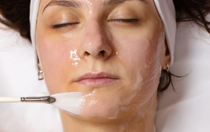 cosmetologist-applying-chemical-peel-product-client-s-face-salon cosmetologist-applying-chemical-peel-product-client-s-face-salon